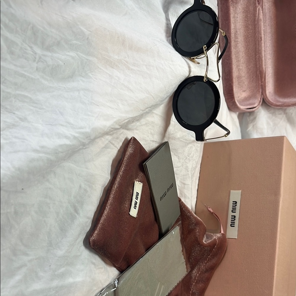 Miu Miu Black Sunglasses with Gold Accents